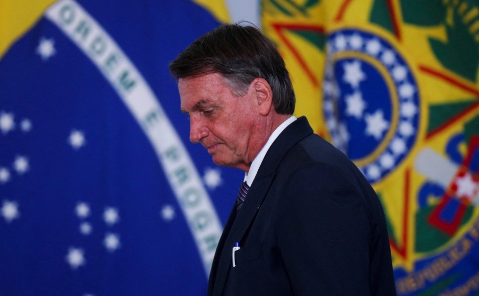 FILE PHOTO: Brazil's President Jair Bolsonaro listens to Brazil's Environment Minister Joaquim Leite during an event to promote the production and sustainable use of Biomethane at the Planalto Palace in Brasilia, Brazil March 21, 2022.REUTERS/Adriano Mach