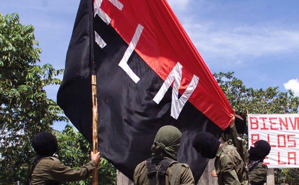 Members of the National Liberation Army (ELN) set the organization's flag in San Francisco, a mountainous region in northern Colombia, where representatives of the government met with rebel leaders , Monday, Oct. 12, 1998. After the meeting the participan