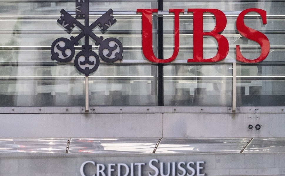 epa10686607 The two logos of the banks UBS and Credit Suisse in Zurich, Switzerland, 12 June 2023. "UBS has completed the legal closing of its acquisition of Credit Suisse" Swiss bank UBS, now Switzerland's only major bank, announced in an open letter pub