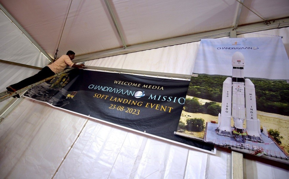 epa10815351 Indian labourers hang a poster during the soft landing of the 'Chandrayaan-3 Mission' event at ISRO Telemetry, Tracking and Command Network (ISTRAC) in Bangalore, India, 23 August 2023. Indian Space Research Organisation (ISRO) space explorati