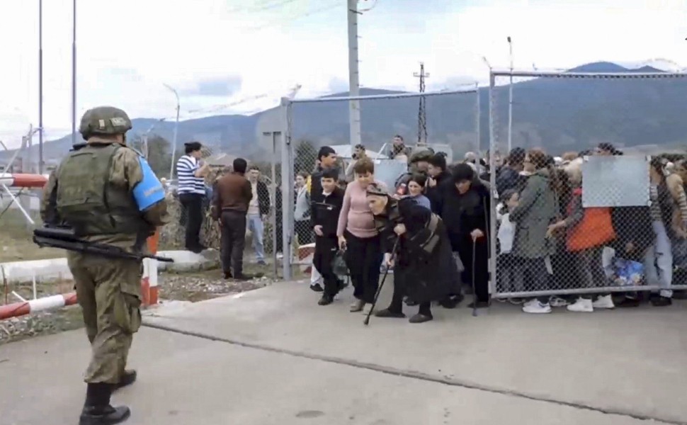epa10873895 A still image taken from a handout video provided by the Russian Defence Ministry press-service shows civilians entering a Russian peacekeepers' camp near Stepanakert, Nagorno-Karabakh, 21 September 2023. About 5,000 people have been brought t