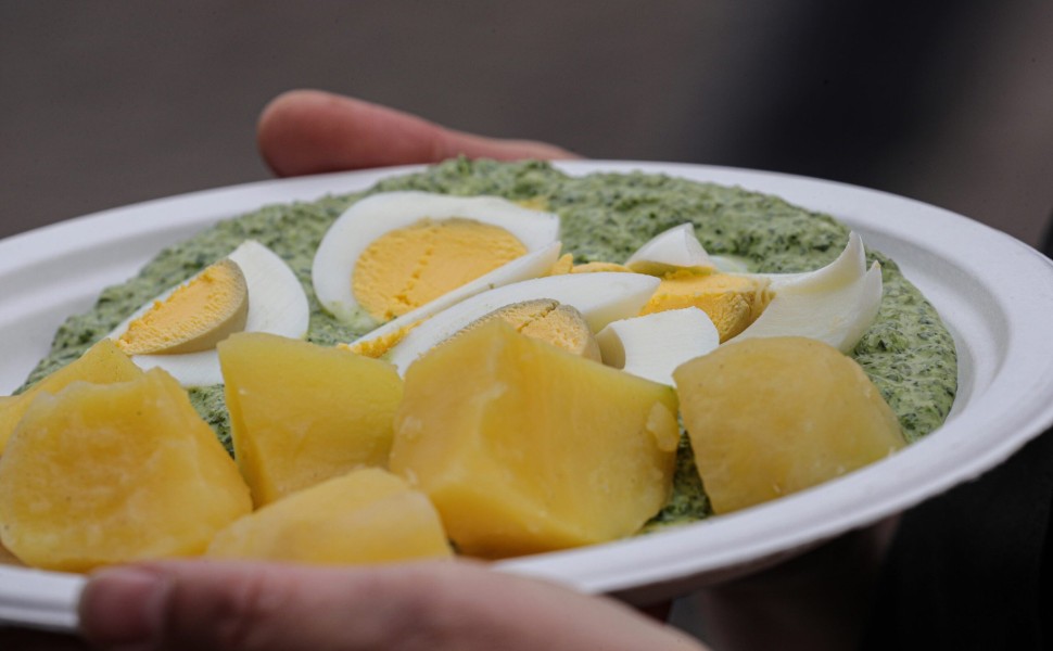 epa07629856 A view of a plate with potatoes, eggs and Green Sauce for the world record attempt on the Green Sauce Day in downtown Frankfurt Main, Germany, 06 June 2019. To set the world record, a total of 231,775 portions of green sauce must be eaten on F