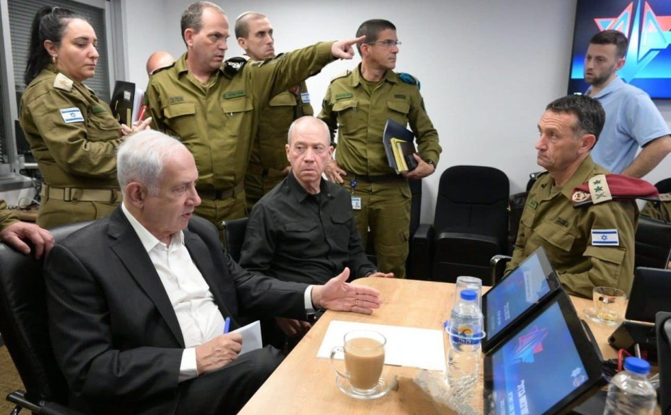 epa10907440 A handout photo made available by the Israeli Government Press Office shows Israeli Prime Minister Benjamin Netanyahu (L) during a situation assessment meeting in Tel Aviv, Israel, 08 October 2023. Rocket barrages were launched from the Gaza S