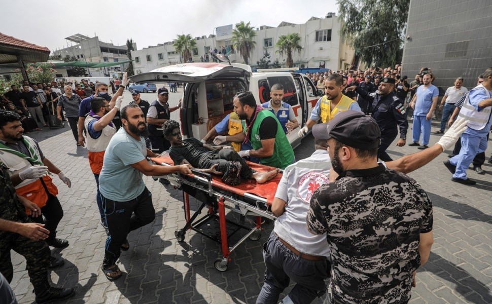 epa10909024 Palestinians rush a wounded youth to an ambulance after an Israeli air strike in Gaza City, 09 October 2023. The Israeli army announced on 09 October, it carried out over 500 strikes on targets across the Gaza Strip overnight. Palestinian offi
