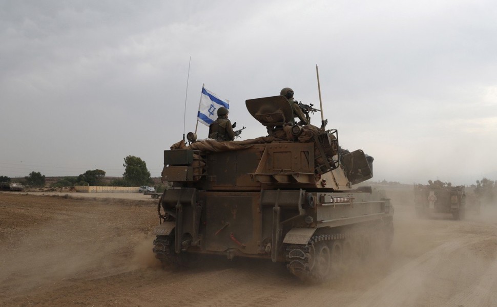 epaselect epa10909875 Israeli soldiers on military vehicles maneuver at an area along the border with Gaza, southern Israel, 09 October 2023. Israeli chief military spokesperson Rear-Admiral Daniel Hagari said on 09 October that the country had drafted a 