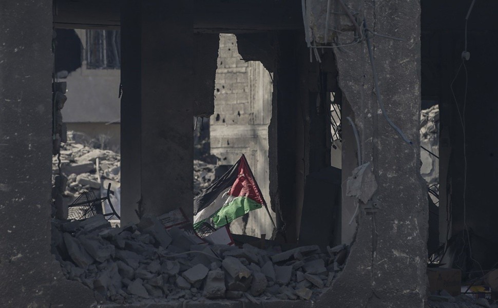 epaselect epa10911574 A Palestinian flag flies among the rubble in the destroyed Al-Ramal neigbourhood following an Israeli air strike in Gaza City, 10 October 2023. More than 800 people have been killed and over 4,000 have been injured according to the P