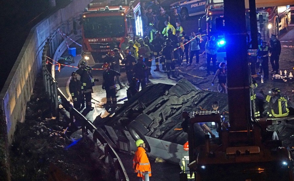 epa10898703 Firefighters work at the site where a passenger bus fell from an overpass ending up on railway tracks in Mestre, near Venice, Italy, late 03 October 2023 (issued 04 October 2023). At least 21 people died in the accident and 15 others were inju