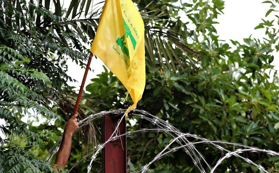 epa08539285 Protestors fix a Hezbollah flag on the barbed wire during a demonstration by supporters of Hezbollah, Lebanese communist party, and other Lebanese national parties at the US embassy against US interference in Lebanon's affairs, in Awkar area n