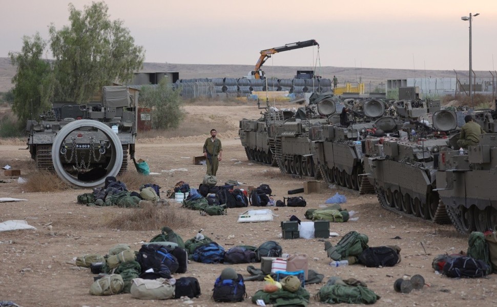 epaselect epa10909663 Israeli reservists prepare next to armored personnel carriers (APCs) at a military camp near Beer Sheva, Israel, 09 October 2023. Israeli chief military spokesperson Rear-Admiral Daniel Hagari said on 09 October that the country had 