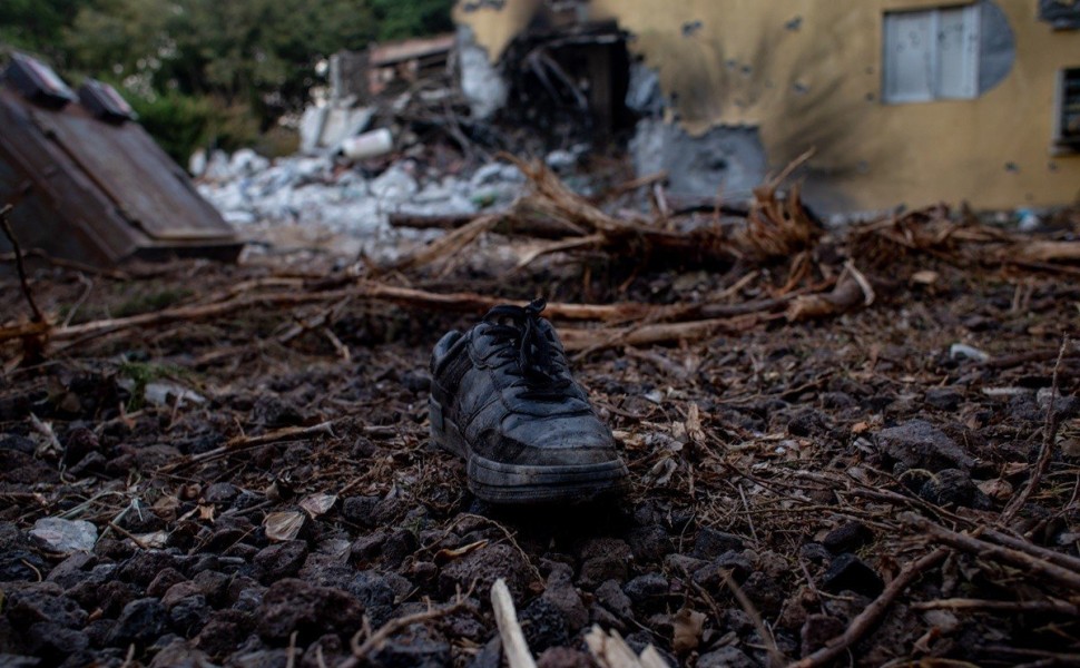 epa10913890 A boot lies on the ground outside a damaged house in Be'eri, Israel, 11 October 2023. According to Israeli officials, 108 Israeli bodies were found in the Be'eri kibbutz, near the Gaza border, following Hamas attack on 07 October. More than 1,