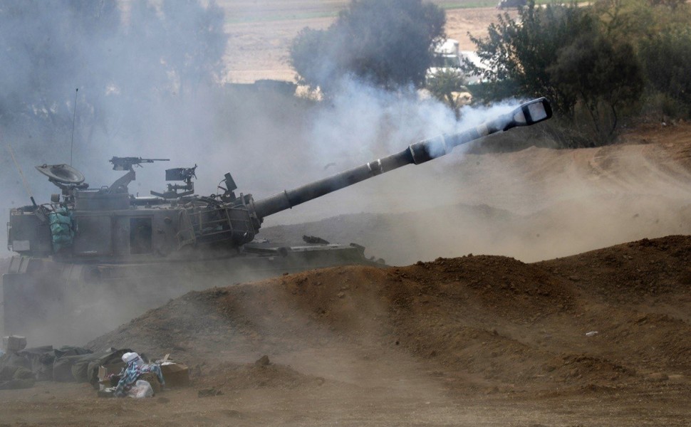 epa10917170 An Israeli artillery unit fires towards Gaza at a position along the border in southern Israel, 13 October 2023. The Israeli Defense Force (IDF) on 13 October called for the evacuation of all civilians of northern Gaza ahead of an expected gro
