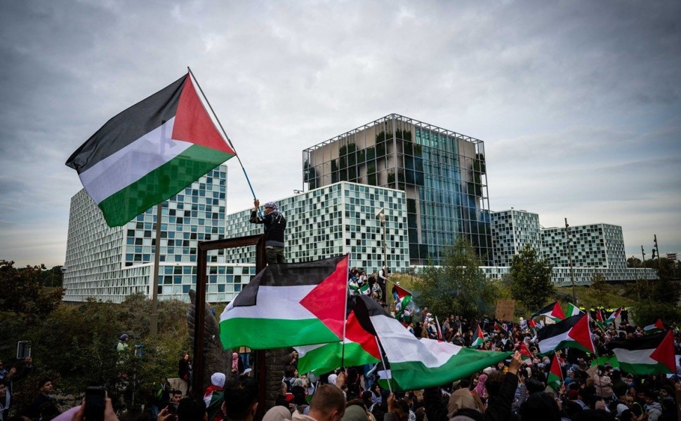 epa10925907 Demonstrators with Palestinian flags protest outside the International Criminal Court to show support for Palestinians in the Gaza Strip, in The Hague, Netherlands, 18 October 2023. Thousands of Israelis and Palestinians have been killed since