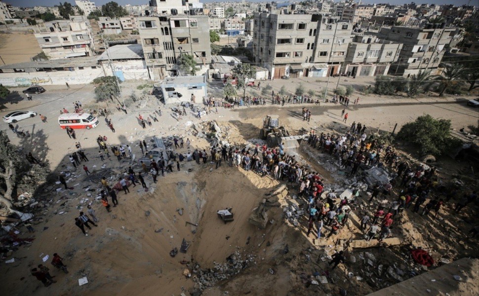 epa10921460 Palestinians search for bodies and survivors in the rubble of a residential building leveled in an Israeli airstrike, in Khan Younis refugee camp in the southern Gaza Strip, on 16 October 2023  Israel has called for the evacuation of all civil