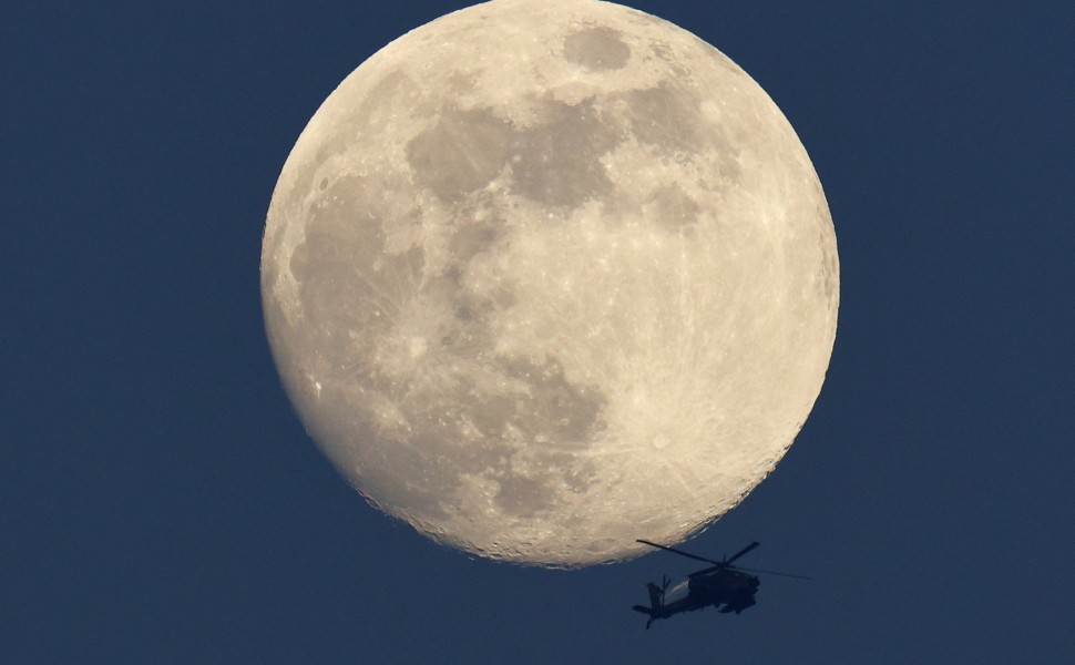 Ελικόπτερο «Απάτσι» στον ουρανό της Γάζας πετάει μπροστά από το φεγγάρι / Reuters