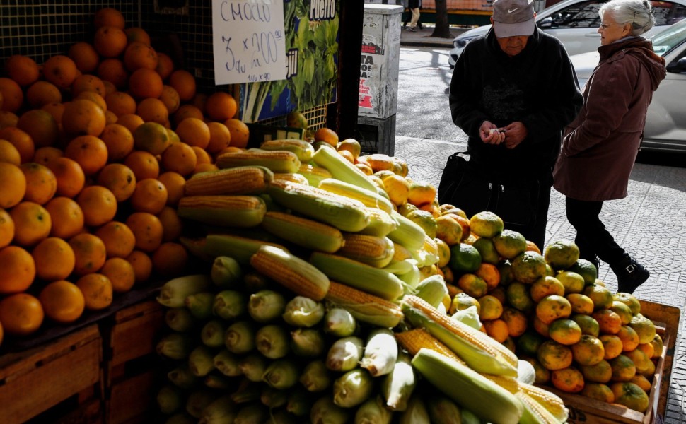 A costumer counts money before buying tangerines in a green grocery store, as Argentines struggle amid rising inflation, in Buenos Aires, Argentina May 11, 2023. REUTERS/Agustin Marcarian