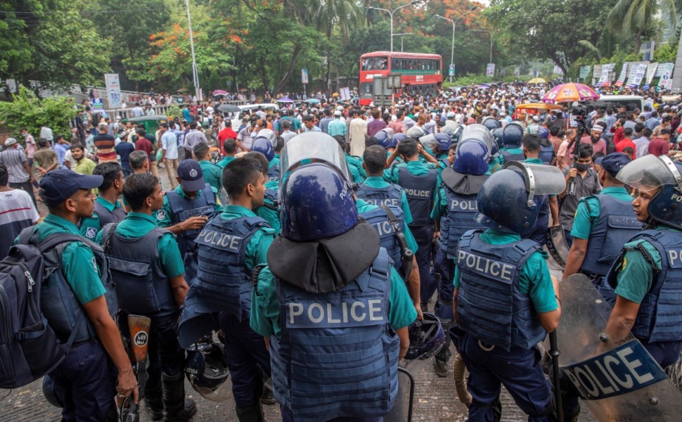 epa10683462 Bangladesh police officers stand guard as Jamaat-e-Islami members join a rally at the Institute of Engineers' auditorium in Dhaka, Bangladesh 10 June 2023. Protesters called for the release of party chief Shafiqur Rahman and other leaders, the