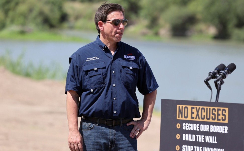 epa10712693 US Republican presidential candidate and Florida Governor Ron DeSantis looks on as Florida Rep. Kiyan Michael (not pictured) speaks during a campaign stop at the border near the Rio Grande river near Eagle Pass,Texas, USA, 26 June 2023.  EPA/A