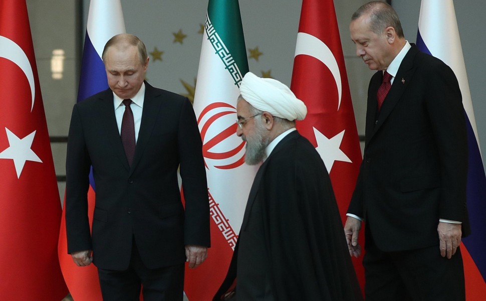 epa06644892 Turkish President Recep Tayyip Erdogan (R), Russian President Vladimir Putin (L) and Iranian President Hassan Rouhani (C) during their meeting at the Presidential Palace in Ankara, Turkey, 04 April 2018. Erdogan, Putin and Rouhani are in Ankar